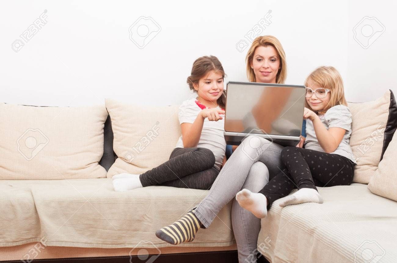 Happy Family Surfing Or Browsing Internet Together Using Laptop Within Family Sofa (Photo 30 of 30)