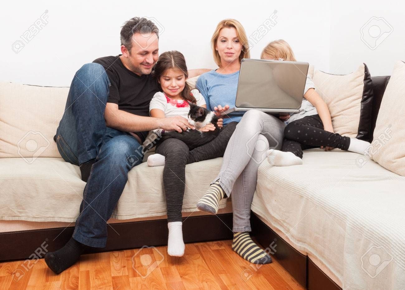 Happy Young Family Using Laptop On The Couch Or Sofa In The Living Throughout Family Sofa (Photo 4 of 30)
