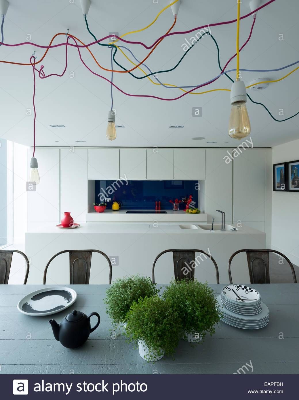 Tolix Steel Chairs Around Wooden Farmhouse Table In Modern Kitchen With Regard To Nud Pendant Lights (View 7 of 15)