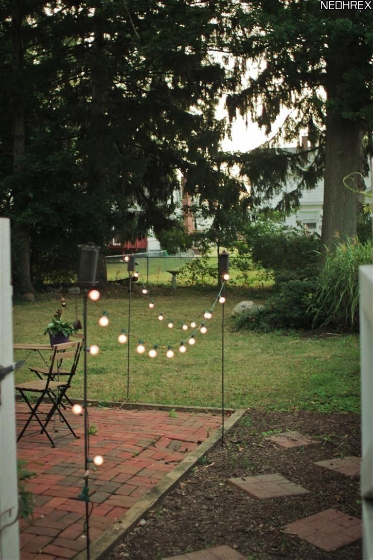 Tiki Torches And Solar Lights Border Patio Area (View 11 of 20)
