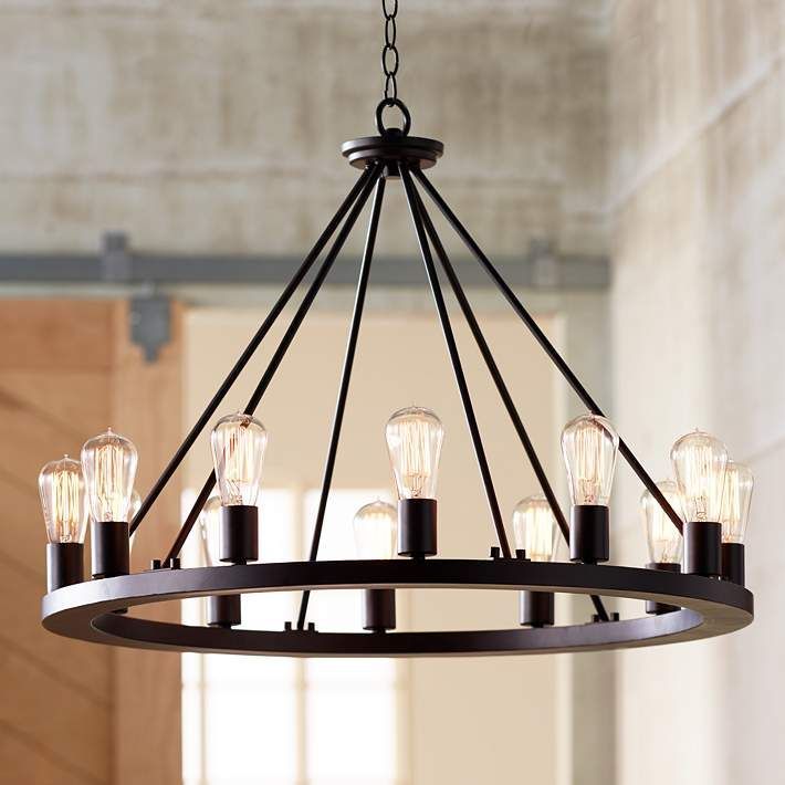 Lacey 28" Wide Round Black 12 Light Wagon Wheel Chandelier Pertaining To Black Wagon Wheel Ring Chandeliers (Photo 2 of 15)